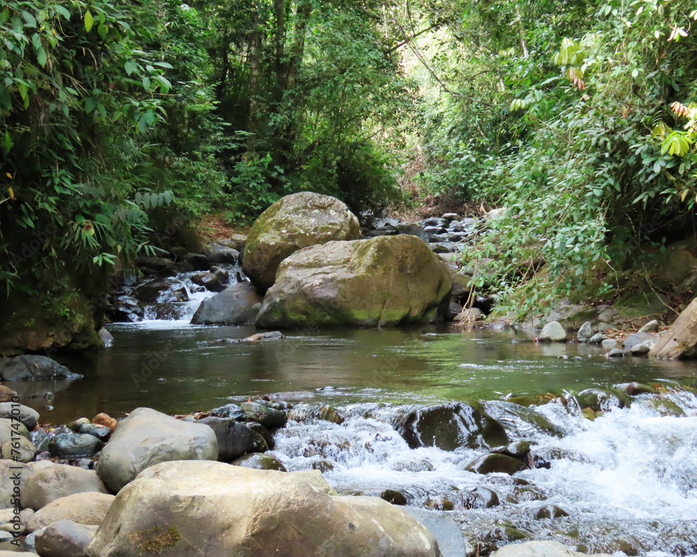 landscape in the river of crystal clear water with large and small stones, surrounded by tropical nature landscape in the river of crystal clear water with large and small stones, surrounded by tropical nature