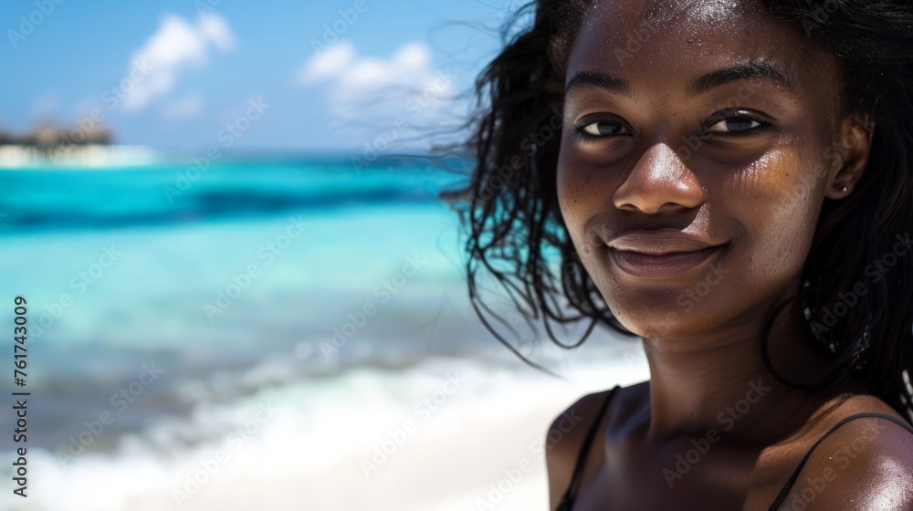 A woman stands on a sandy beach next to the ocean, looking out at the vast water ahead of her. A woman stands on a sandy beach next to the ocean, looking out at the vast water ahead of her.