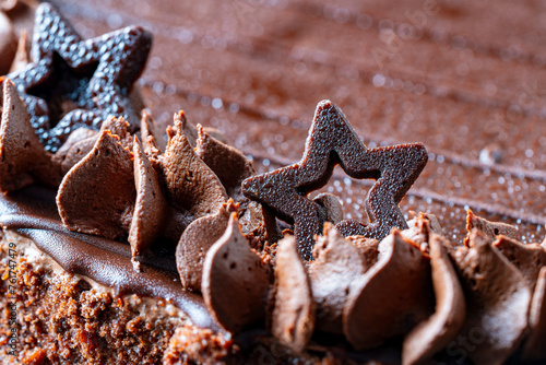 Piece of chocolate cake with star and icing, closeup