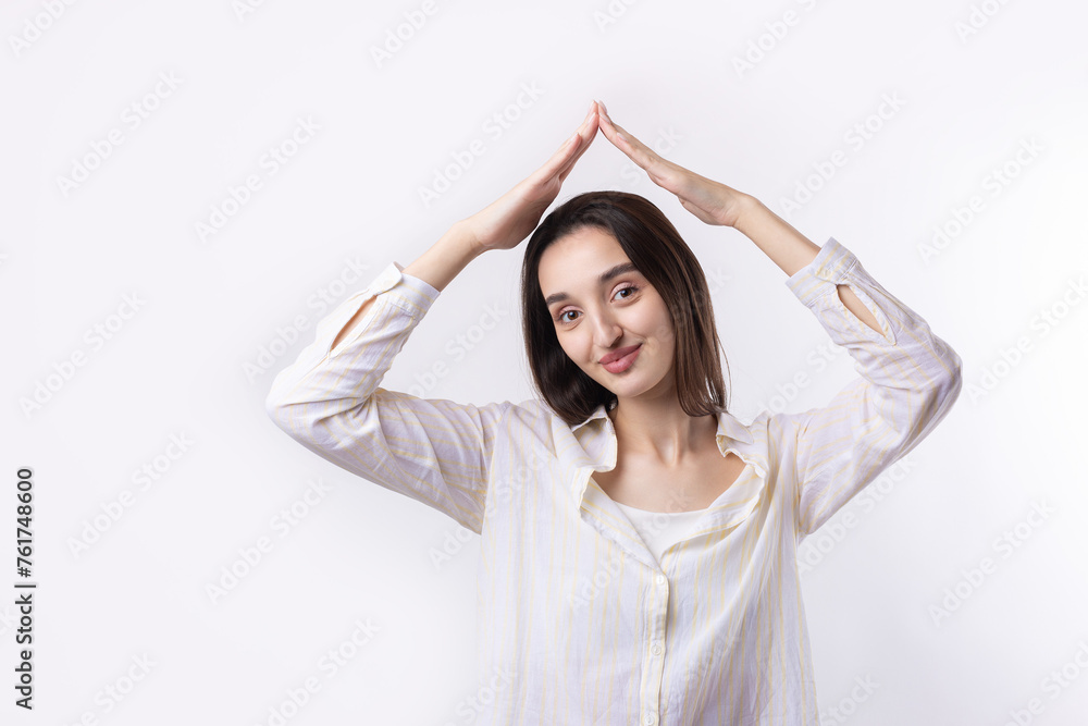 Portrait of a serious young woman showing stop gesture with her palm over white background Portrait of a serious young woman showing stop gesture with her palm over white background