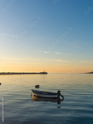 One boat and the pier of Umag at sunset © Rodrigo