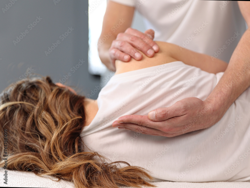 Woman having Chiropractic back adjustment. Osteopathy, Physiotherapy, Sport Injury rehabilitation