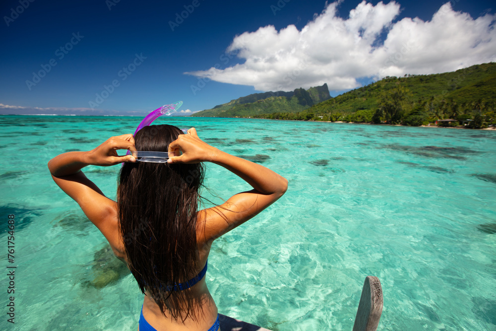 Beach travel vacation sport girl ready to snorkel in coral reefs of turquoise waters in Tahiti, French Polynesia. Image is completely unretouched. Authentic real people. Raw Image - obrazy, fototapety, plakaty 