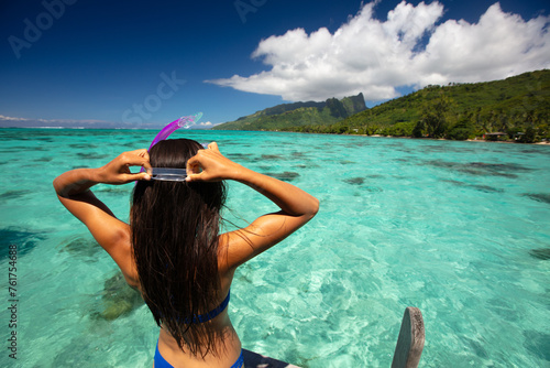 Beach travel vacation sport girl ready to snorkel in coral reefs of turquoise waters in Tahiti, French Polynesia. Image is completely unretouched. Authentic real people. Raw Image