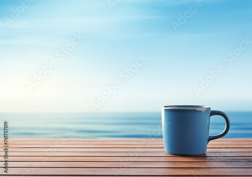 A blue ceramic mug in the morning sunlight on a wooden countertop against the backdrop of the sea. Creates a serene and tranquil scene, perfect for promoting coastal retreats, seaside cafes