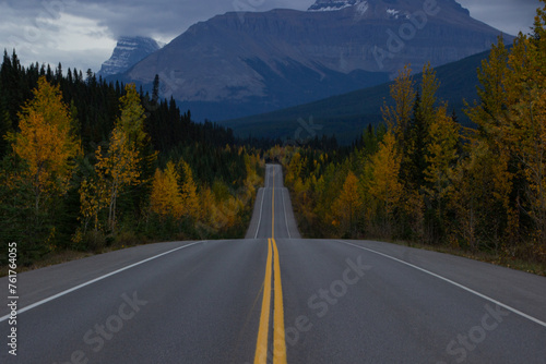Beautiful straight road in Canada in autumn.