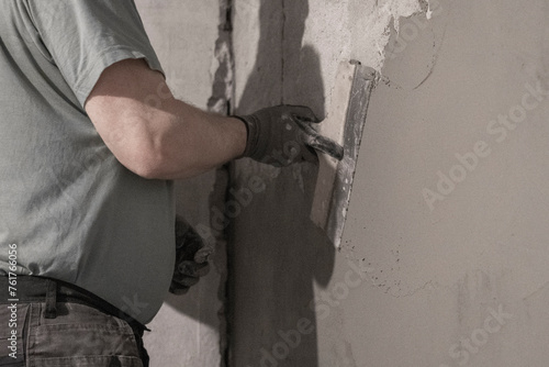 Worker Plastering Wall: Expert Renovation in Progress Inside Living Space