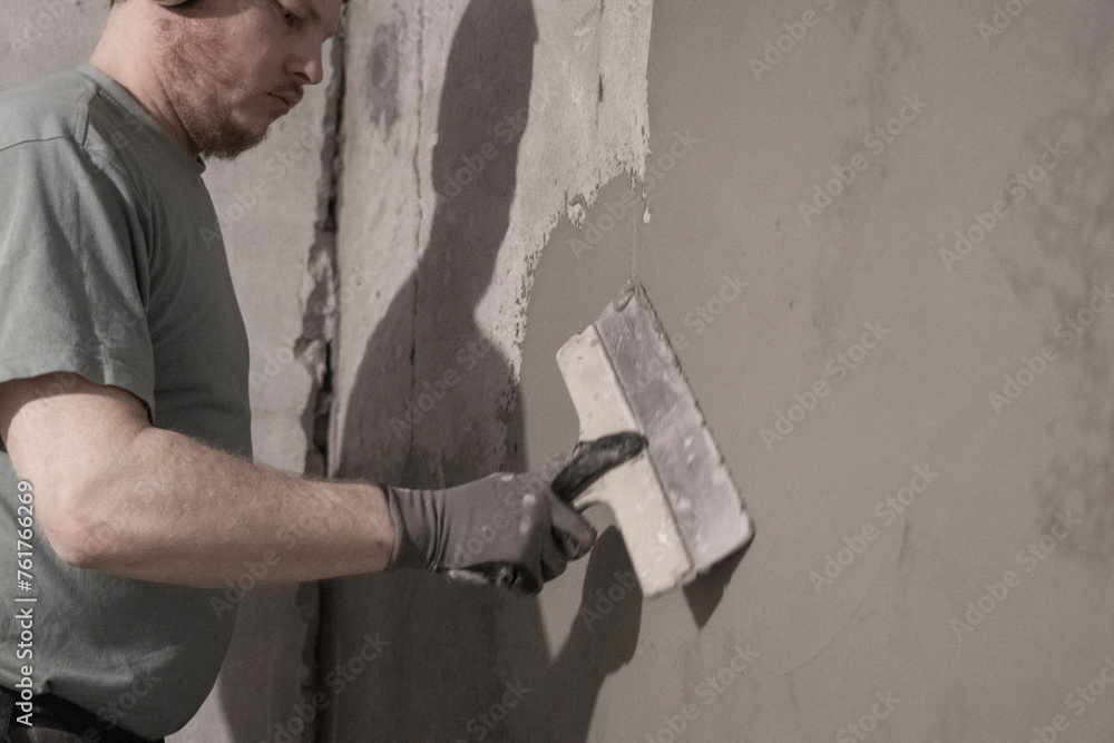 Man Plastering Wall: Skillfully Applying Plaster for Smooth Surface Finish. Man Plastering Wall: Skillfully Applying Plaster for Smooth Surface Finish.