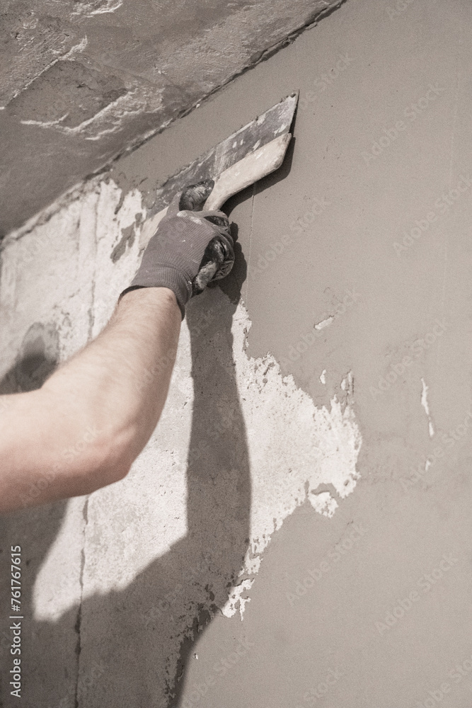 Artisan Skill: Precise Wall Smoothing by Worker Using Spatula in Interior Room. Artisan Skill: Precise Wall Smoothing by Worker Using Spatula in Interior Room.