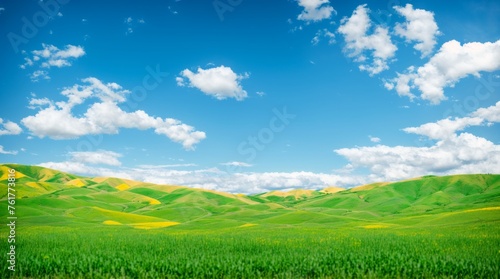 Leafy green hills under a dynamic blue sky decorated with fluffy clouds 