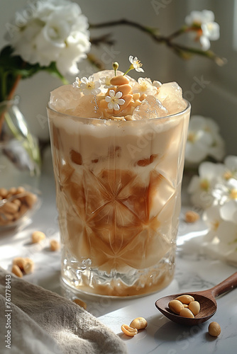 White marble countertop and white clean wall background, featuring Ice Latte with Peanut Butter and Flowers. The ice latte gets its unique light beige color from a blend of coffee, peanut butter