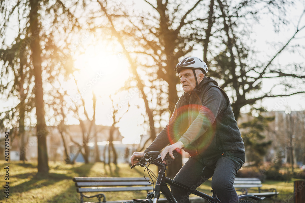 Man Enjoying a Bicycle Ride in a Park at Sunset Man Enjoying a Bicycle Ride in a Park at Sunset
