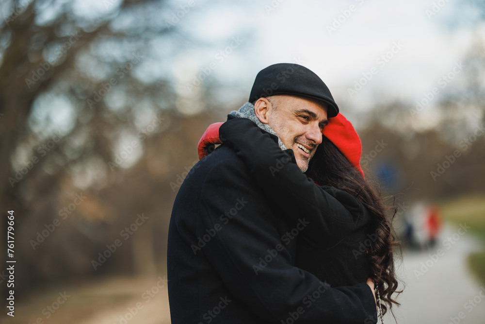 Couple Embracing in a Park During a Winter Afternoon Couple Embracing in a Park During a Winter Afternoon