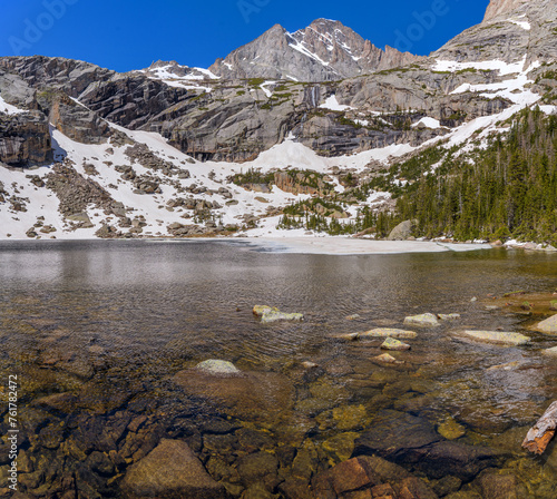 Black Lake and McHenrys Peak - A close-up view of pristine Black Lake, with McHenrys Peak towering at shore, on a calm and sunny Spring morning. Rocky Mountain National Park, Colorado, USA. photo