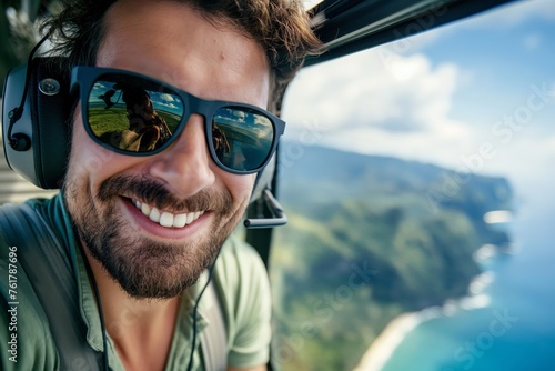 Close-up of a smiling man with sunglasses reflecting scenery during helicopter flight
