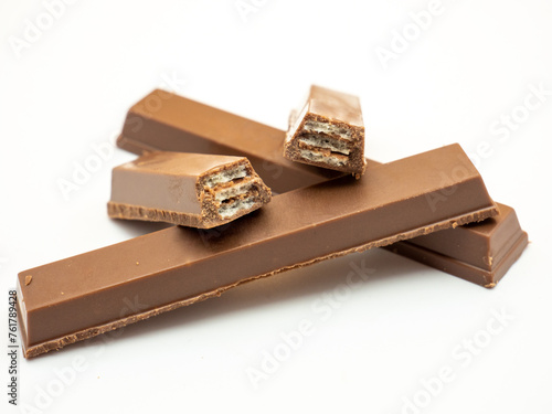 pile of delicious broken chocolate wafer on white background