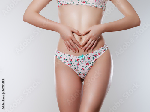 Tanned woman in top form, perfect body shape. Parts of woman body in underwear, studio shoot.