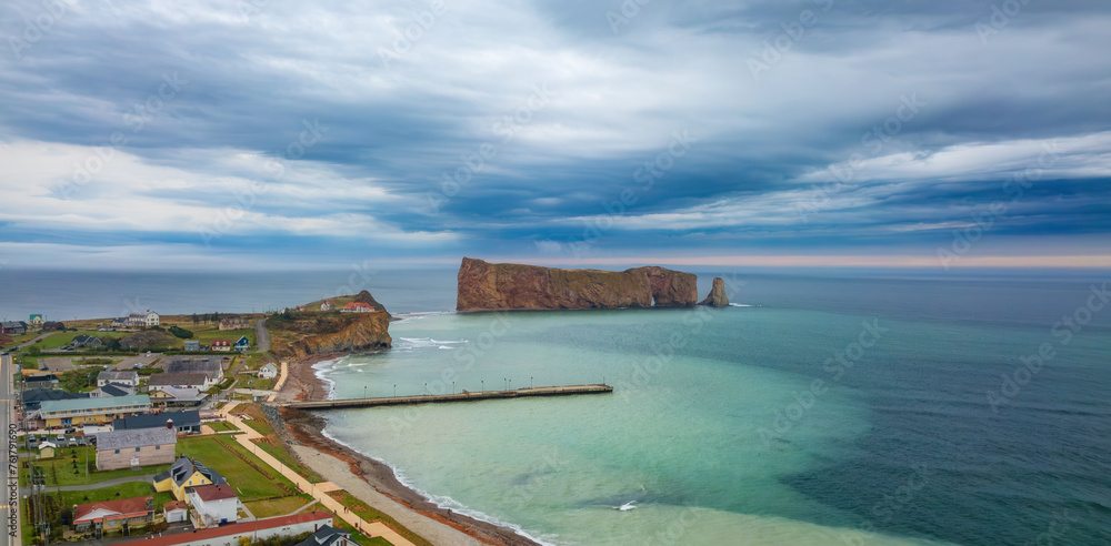 Town on the Atlantic Ocean Coast during a cloudy sunset. Perce, Quebec, Canada. Town on the Atlantic Ocean Coast during a cloudy sunset. Perce, Quebec, Canada.