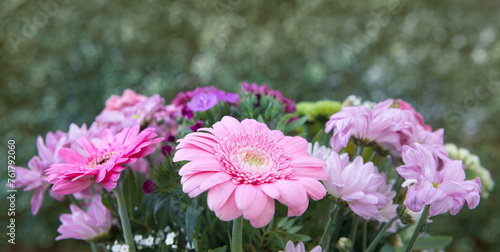 Colorful mixed flower bouquet isolated on blur green background.