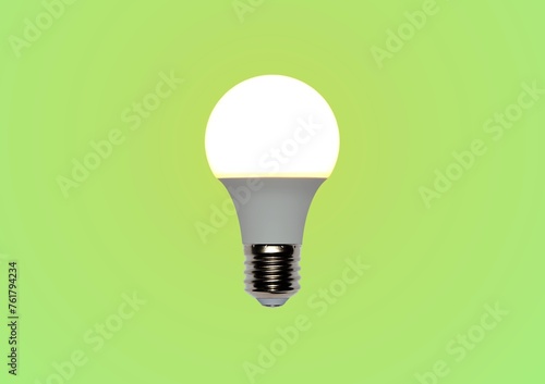 Energy saving glowing LED bulb with E27 screw thread on gradient green isolated background photo