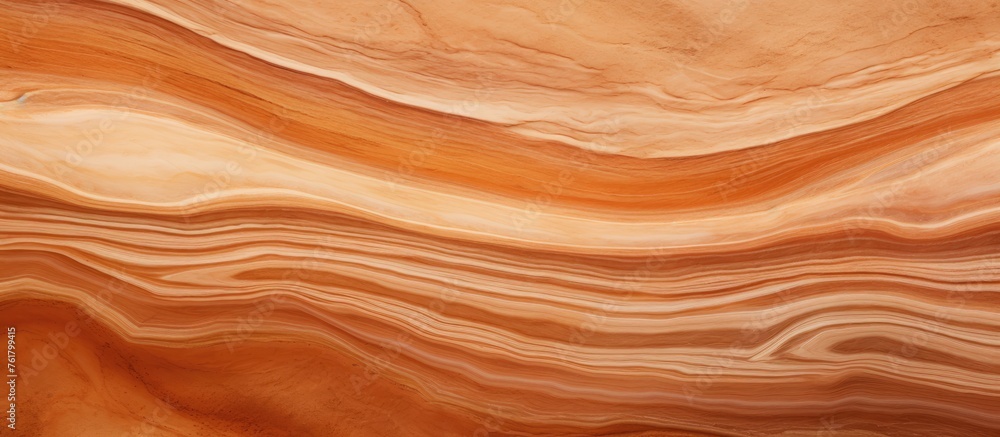 A closeup of a hardwood surface with a peach marble texture created using wood stain and varnish. The pattern resembles a landscape of swirling amber tones