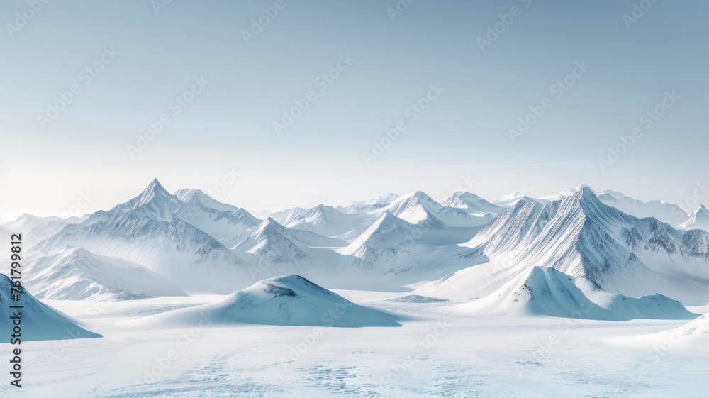 Fototapeta premium Pristine snowy mountain landscape - A breathtaking panoramic view of snow-covered mountains under a clear blue sky evoking solitude