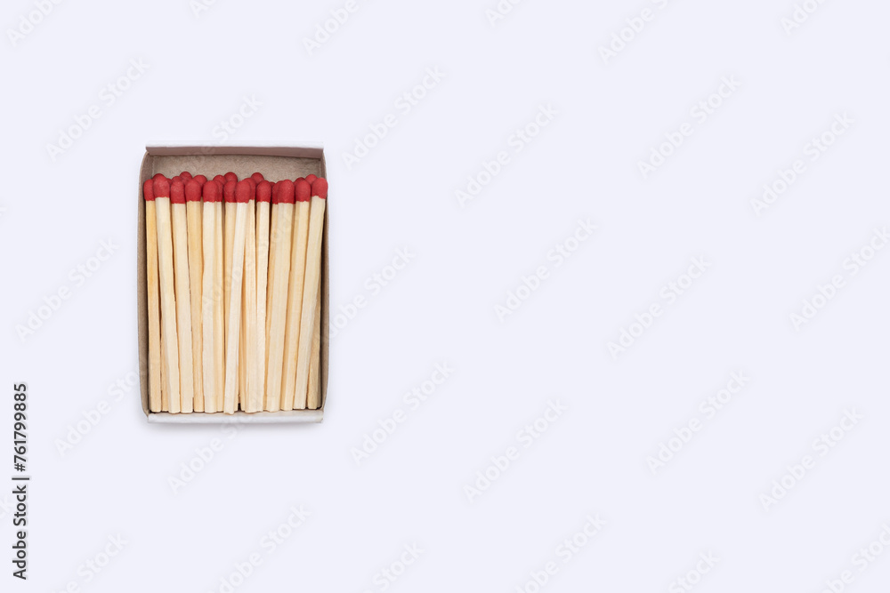 Matches in an open matchbox on a white background. Top view of open matchbox isolated on white background. Close-up of matches with empty space for text Matches in an open matchbox on a white background. Top view of open matchbox isolated on white background. Close-up of matches with empty space for text