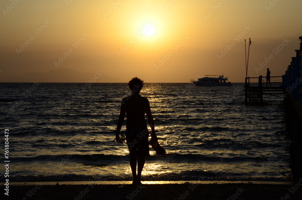 silhouette of a man against the background of the sea