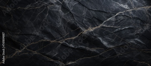 A close up of a black marble texture mimicking the intricate patterns of frost on a freezing winter landscape