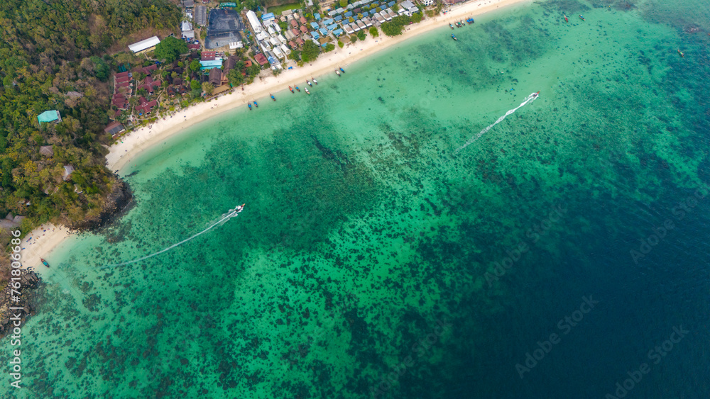 Long beach at Koh Phi Phi island, Krabi, Thailand. Tropical paradise white sand beach with turquoise waters of Andaman sea, aerial view. 