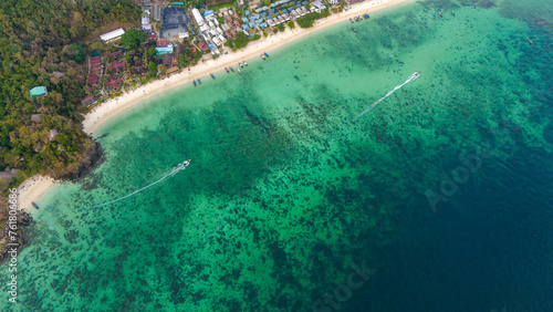 Long beach at Koh Phi Phi island, Krabi, Thailand. Tropical paradise white sand beach with turquoise waters of Andaman sea, aerial view.  © Alisa