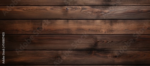 A close up of a brown hardwood plank wall with a wood stain finish, featuring a rectangular pattern resembling brickwork. Tints and shades create a visually appealing textured background