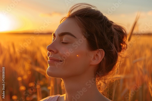 Portrait of smiling woman with closed eyes enjoying life on field at sunset © viktorbond