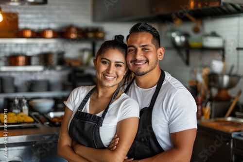 Smiling Hispanic Couple in Restaurant Kitchen, Sharing Success