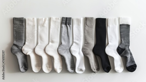 A comprehensive set of long socks in shades of white, gray, and black, presented against a white background for clear comparison