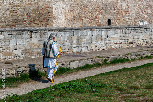 Walking Bulgarian man dressed in traditional costume  photo