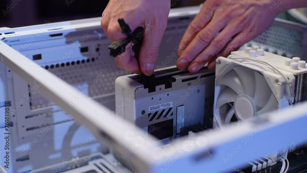 Closeup hands of unrecognizable gamer male plugging in graphics card
