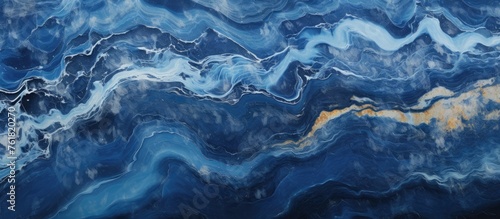 Close up of a natural landscape resembling a blue and white marble texture, reminiscent of wind waves in the ocean with electric blue hues, fluidlike patterns, and a touch of sky reflection