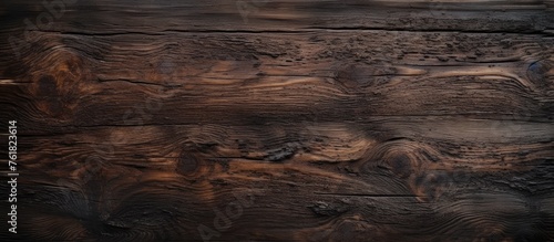 A closeup of a brown hardwood plank wall with a grainy texture and wood stain, showcasing the natural beauty of the wood flooring in a beautiful landscape pattern © AkuAku