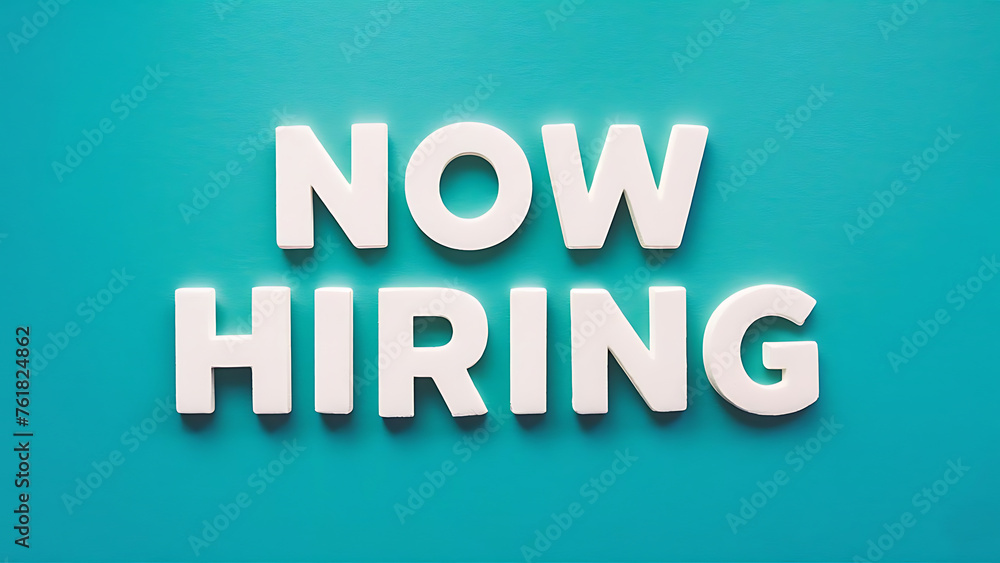 vibrant image featuring bold, white, 3D letters spelling “NOW HIRING” against a bright turquoise background. The text is centrally positioned, and the font is modern and clean