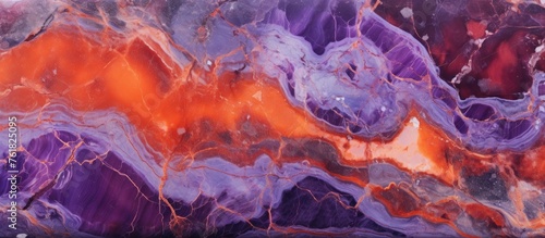 A close up of a vibrant purple and orange painting  with hints of electric blue and magenta  lying on a table. The artwork features a mesmerizing pattern  reminiscent of a fiery landscape