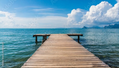 wooden pier with blue sea and sky background © Nichole