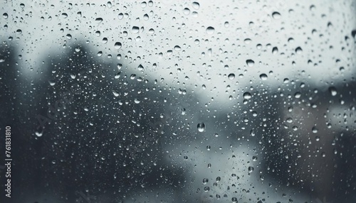 atmospheric minimal grayscale backdrop with rain droplets on glass wet window with rainy drops and dirt spots closeup blurry minimalist monochrome background of dirty window glass with raindrops © Nichole