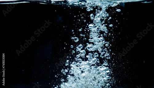 blurry images of clear transperant soda liquid bubbles splashing or sparkling and moving up in black background for represent the refreshing moments after drink carbonated water photo