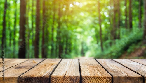 empty wooden table top with blur background of forest