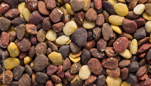 background of large amount of little dark brown red and yellow stones view from above