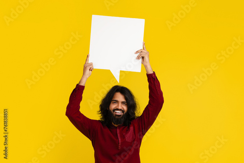 Indian man holding speech bubble with empty space