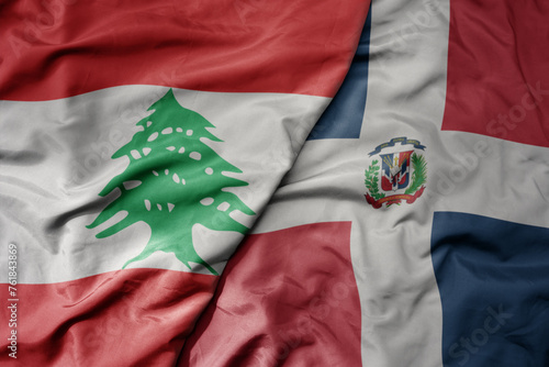 big waving national colorful flag of dominican republic and national flag of lebanon. photo