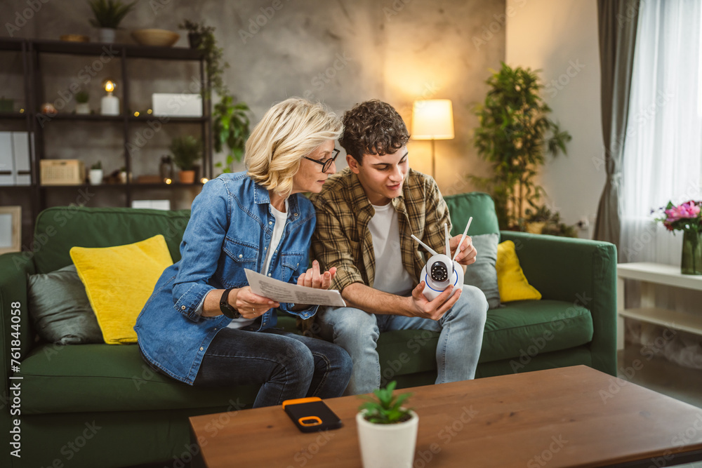 Mother and son adjust and install home cctv video surveillance camera Mother and son adjust and install home cctv video surveillance camera