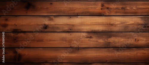 A closeup image showcasing a rectangle of brown hardwood plank flooring, with tints and shades of amber wood stain, as a building material